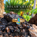 Solar Crest Winton Boulder opal ring in 14K yellow gold, showing red-orange flashes from an angle.