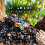 Solar Crest Winton Boulder opal ring in 14K yellow gold, showing red-orange flashes from an angle.