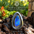 Lagoon Mirage blue and violet boulder opal with aqua and green flashes in a sterling silver shadowbox ring.

