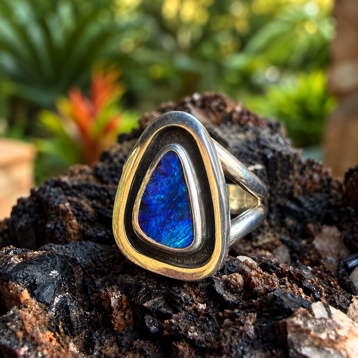 Opposite angled view of Cobalt Cove showing its sterling silver split shank and bright blue opal flash.

