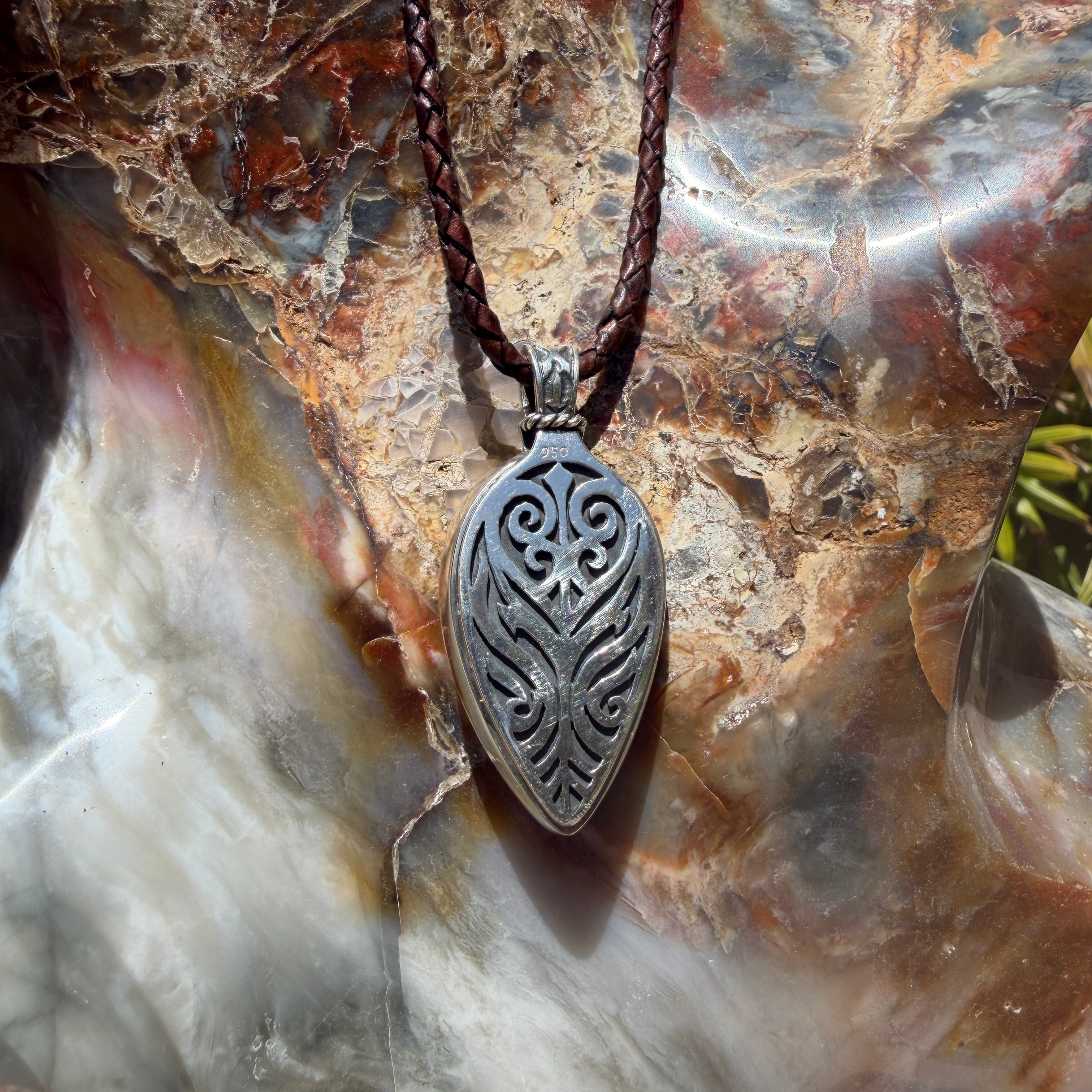 Ancient Tide one-of-a-kind Australian Boulder Opal pendant handcrafted in solid .950 silver by TIDAL OPALS, featuring a natural 31 x 18 mm boulder opal with blue, teal, green, violet, and gold play-of-color, hand-engraved details, and an intricate hand-pierced backplate.