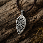 Ancient Tide one-of-a-kind Australian Boulder Opal pendant handcrafted in solid .950 silver by TIDAL OPALS, featuring a natural 31 x 18 mm boulder opal with blue, teal, green, violet, and gold play-of-color, hand-engraved details, and an intricate hand-pierced backplate.