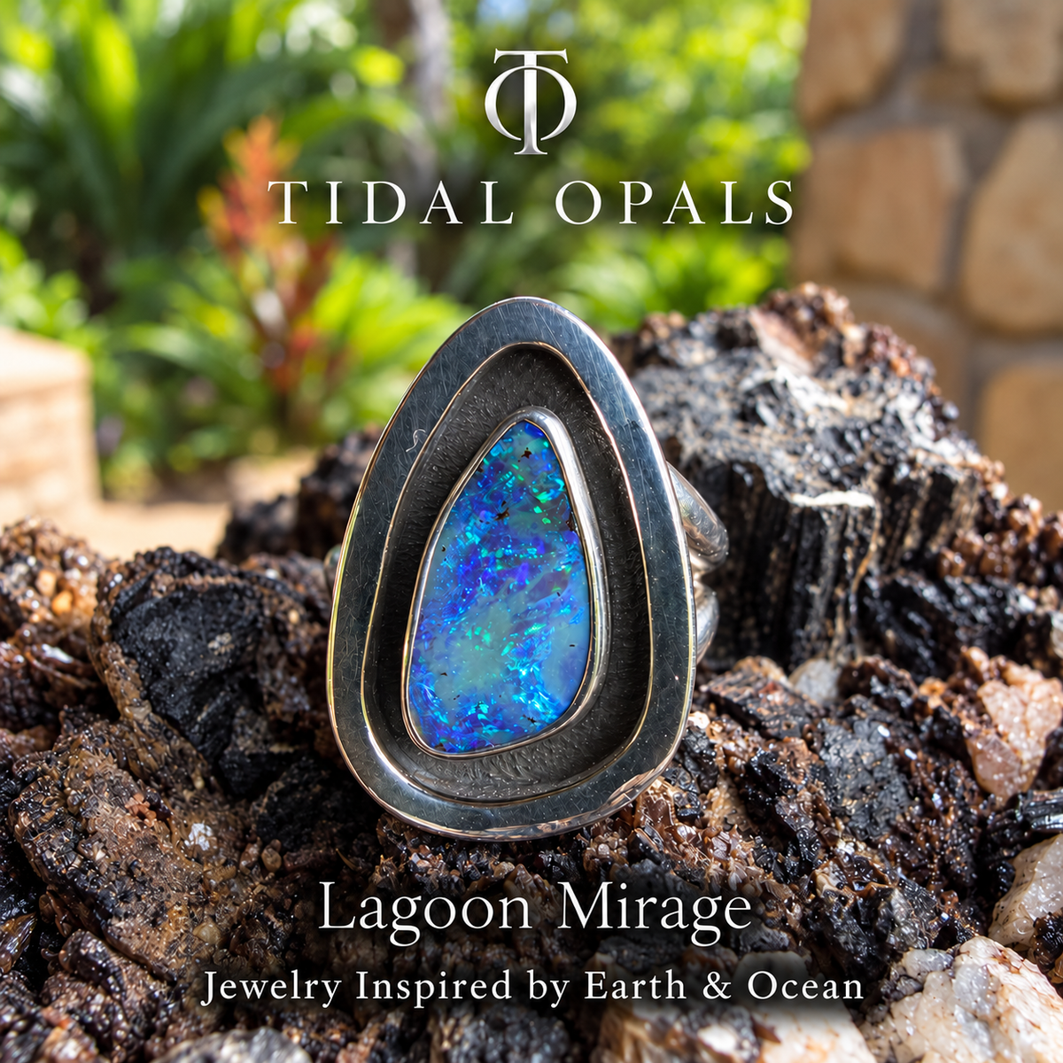 Lagoon Mirage blue and violet boulder opal with aqua and green flashes in a sterling silver shadowbox ring.
