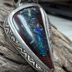 Relic-inspired sterling silver pendant with asymmetrical design and vibrant Australian Boulder Opal centerpiece.