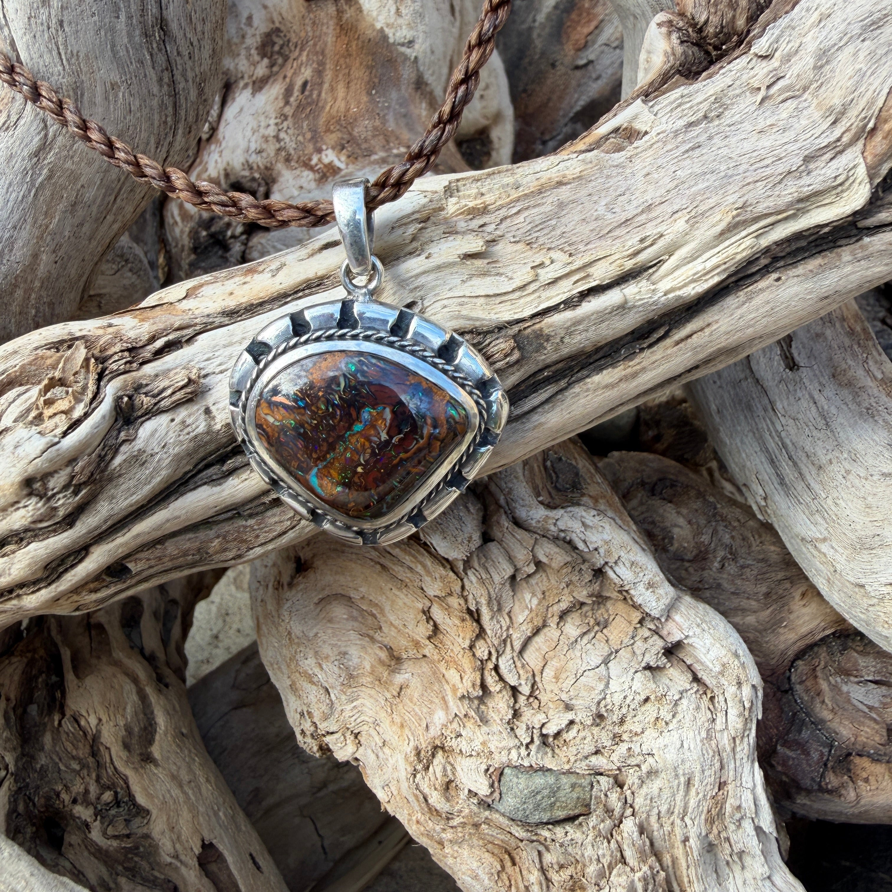 Sea Forge Australian Boulder Opal Pendant handcrafted in sterling silver featuring a genuine 20 × 24 mm Boulder Opal with brilliant blue, green, turquoise, and copper flashes.