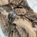 Close-up of the Tidal Confluence Boulder Opal pendant highlighting vivid ocean-inspired colors and handcrafted silver setting.
