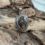 Handmade sterling silver pendant showcasing a genuine Boulder Opal with blue, green, teal, and bronze flashes.