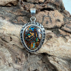 One-of-a-kind Australian Boulder Opal pendant with natural ironstone patterns set in polished sterling silver.