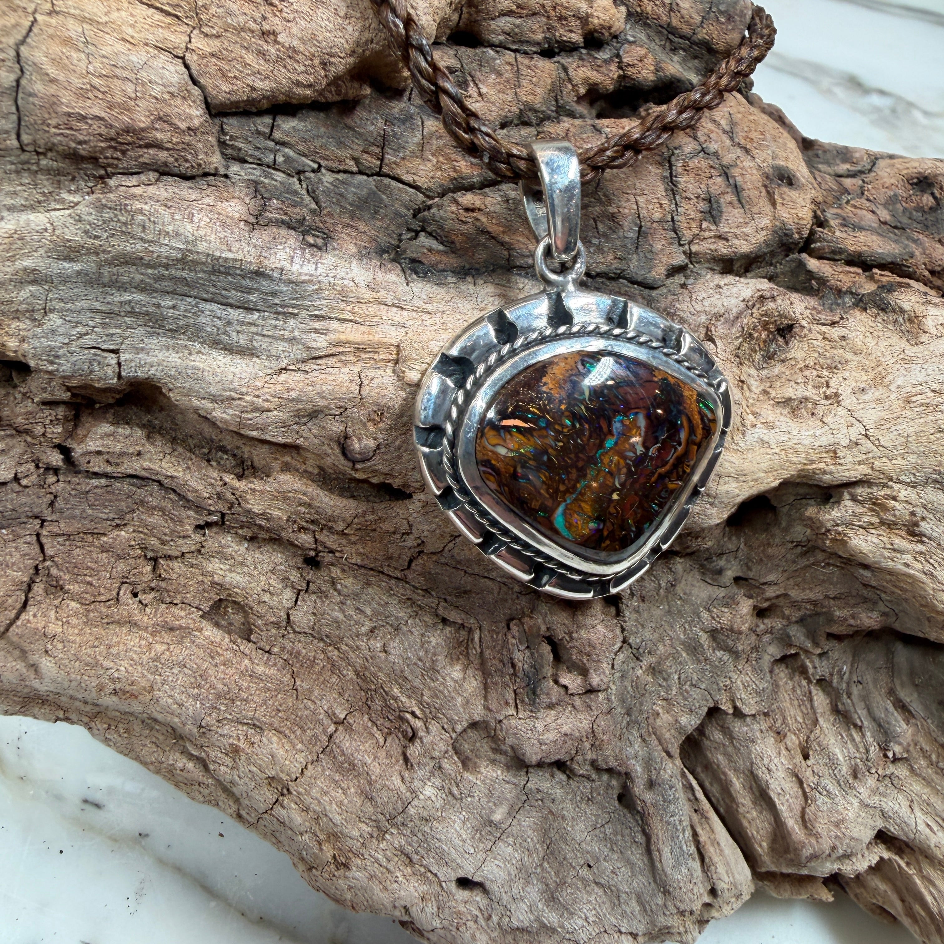 Sea Forge Australian Boulder Opal Pendant handcrafted in sterling silver featuring a genuine 20 × 24 mm Boulder Opal with brilliant blue, green, turquoise, and copper flashes.