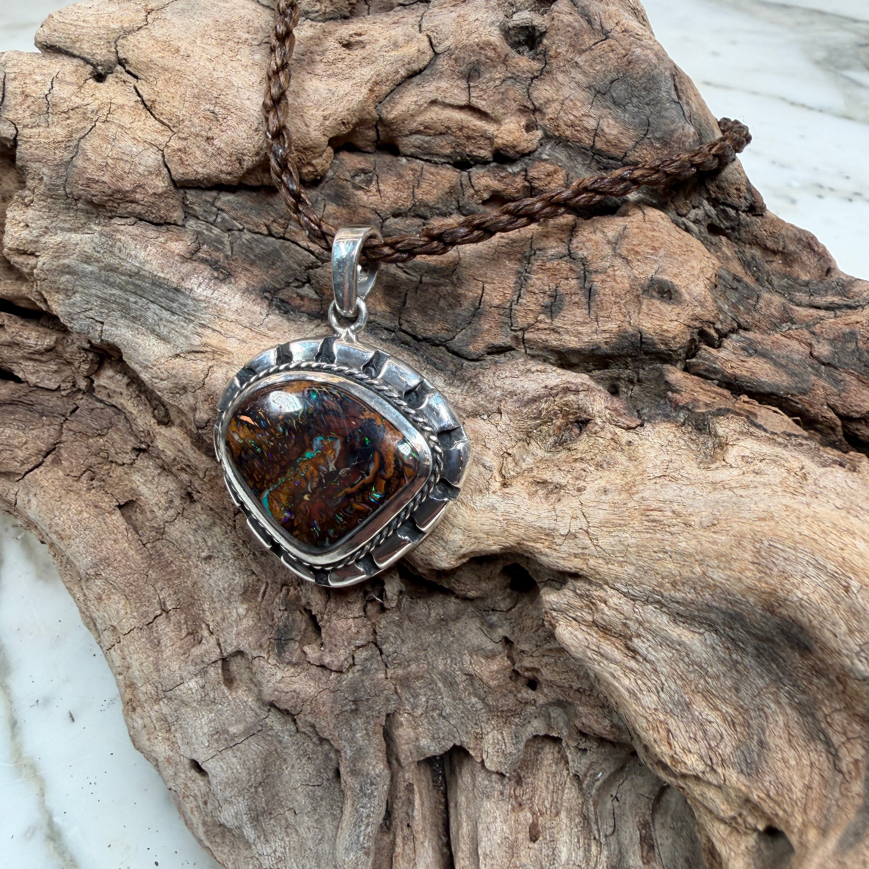 Sea Forge Australian Boulder Opal Pendant handcrafted in sterling silver featuring a genuine 20 × 24 mm Boulder Opal with brilliant blue, green, turquoise, and copper flashes.