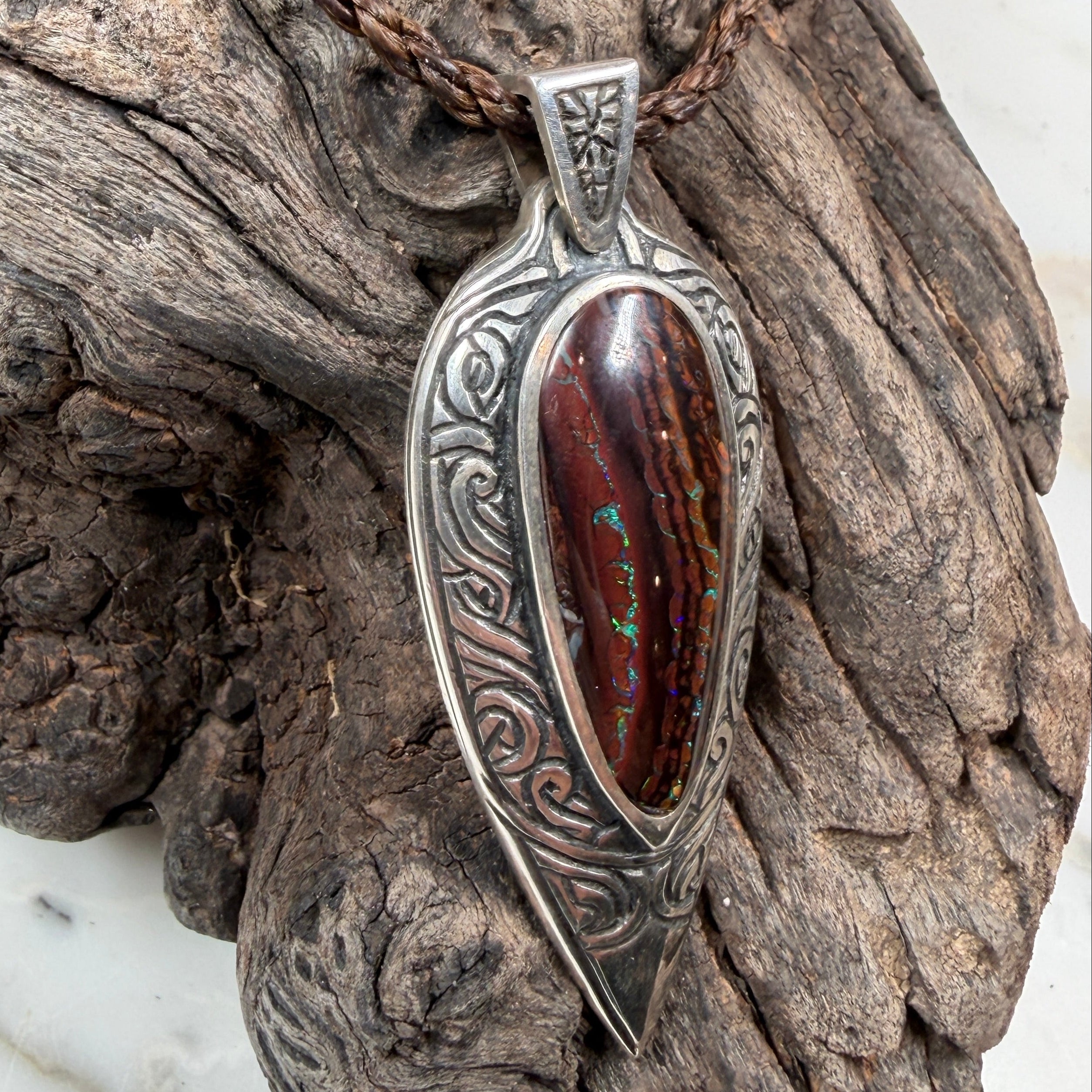 Tidal Koru Relic Boulder Opal Pendant, a one-of-a-kind boulder opal pendant inspired by the ancient Koru symbol of renewal, growth, and eternal movement.