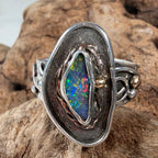 Reef Current handcrafted Australian Boulder Opal ring in .925 sterling silver with a 14K gold rope bezel and gold accents displayed on weathered driftwood.