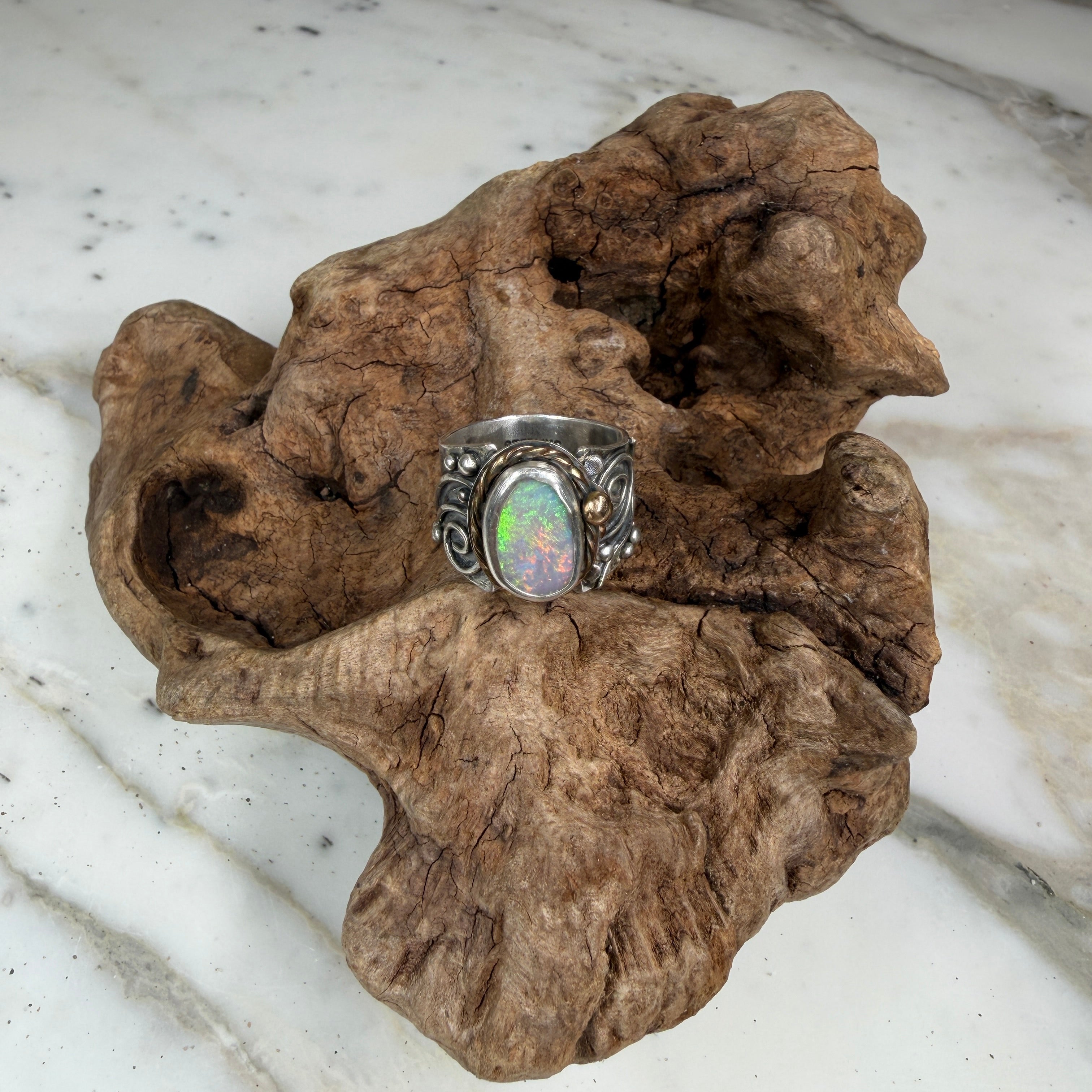 Sunlit Lagoon handcrafted Australian Coober Pedy opal ring in .925 sterling silver with a 14K gold rope bezel accent and gold accent ball.