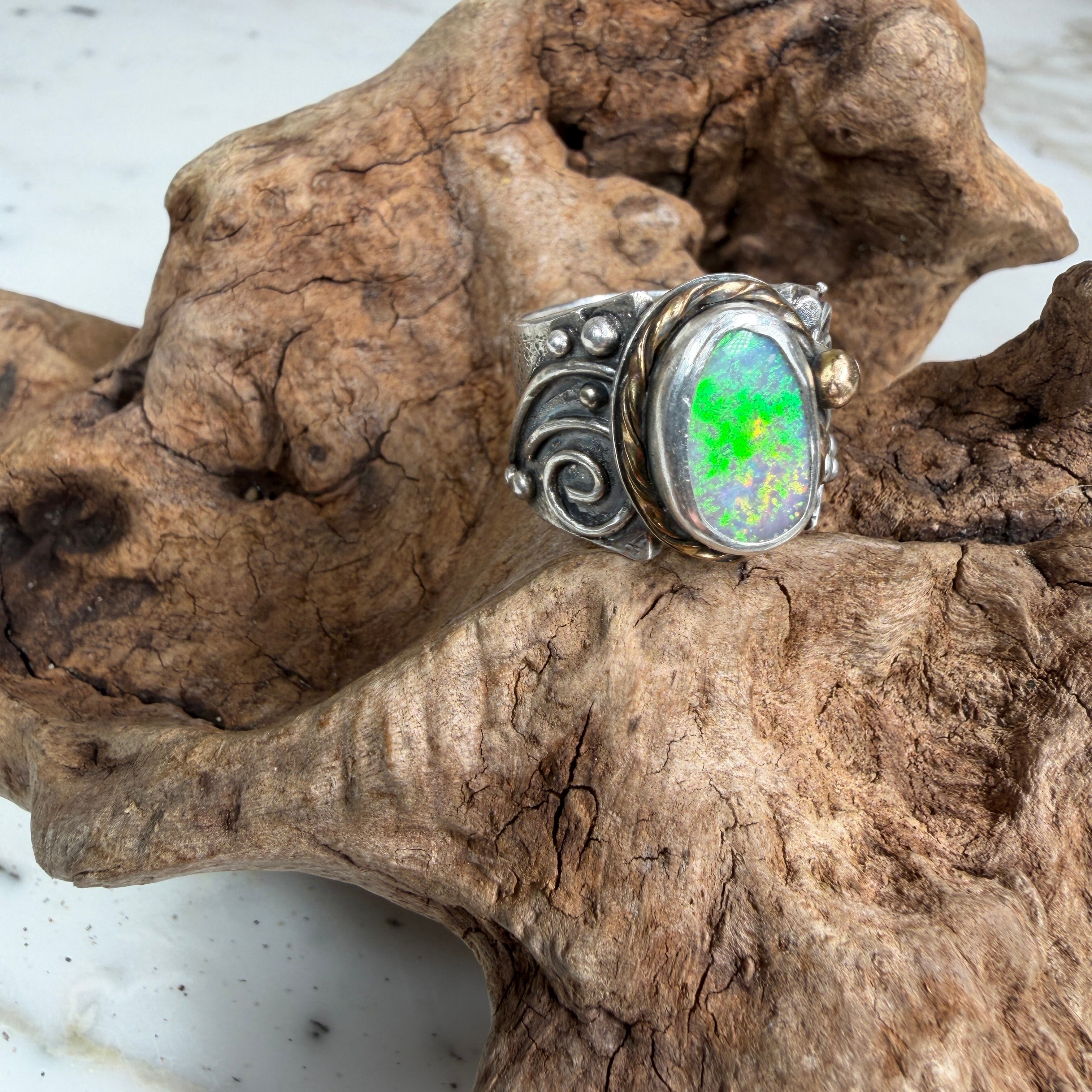 Sunlit Lagoon handcrafted Australian Coober Pedy opal ring in .925 sterling silver with a 14K gold rope bezel accent and gold accent ball.