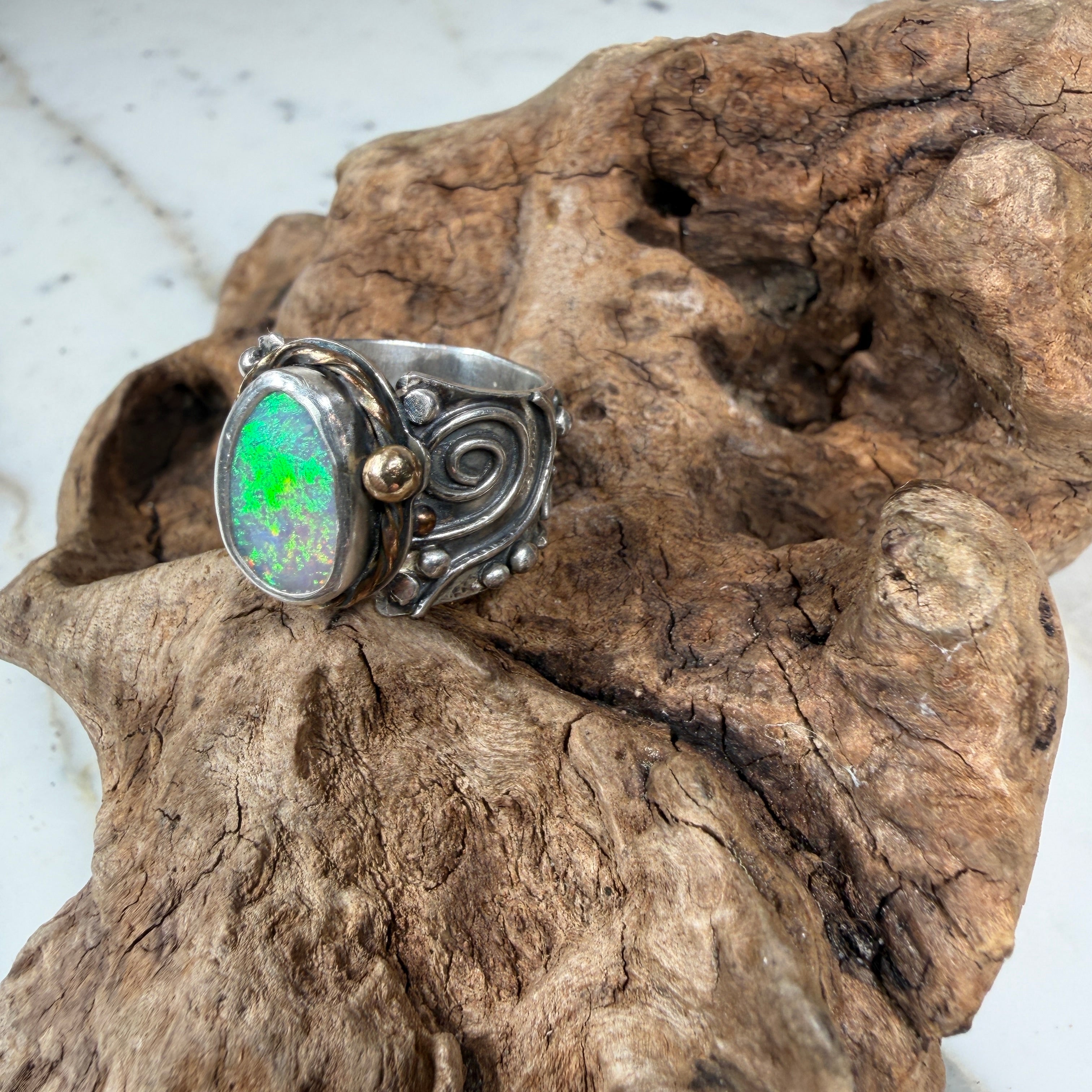Sunlit Lagoon handcrafted Australian Coober Pedy opal ring in .925 sterling silver with a 14K gold rope bezel accent and gold accent ball.