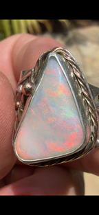 Celestial Tide handcrafted Australian crystal opal ring in .925 sterling silver with a 14K gold rope bezel, gold accents, and sculpted starfish.
