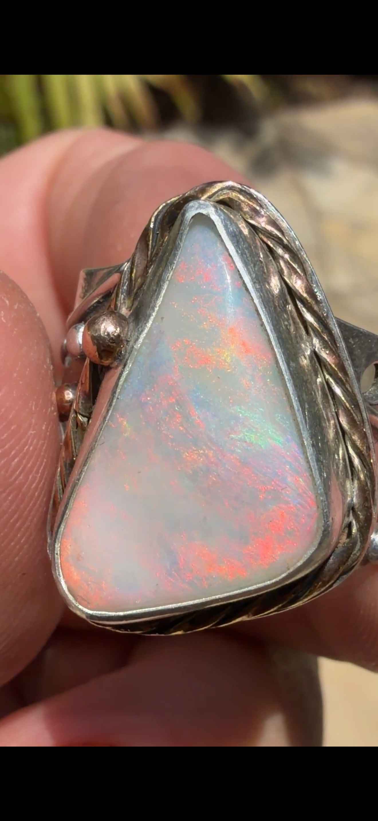 Celestial Tide handcrafted Australian crystal opal ring in .925 sterling silver with a 14K gold rope bezel, gold accents, and sculpted starfish.