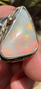 Celestial Tide handcrafted Australian crystal opal ring in .925 sterling silver with a 14K gold rope bezel, gold accents, and sculpted starfish.