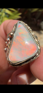 Celestial Tide handcrafted Australian crystal opal ring in .925 sterling silver with a 14K gold rope bezel, gold accents, and sculpted starfish.
