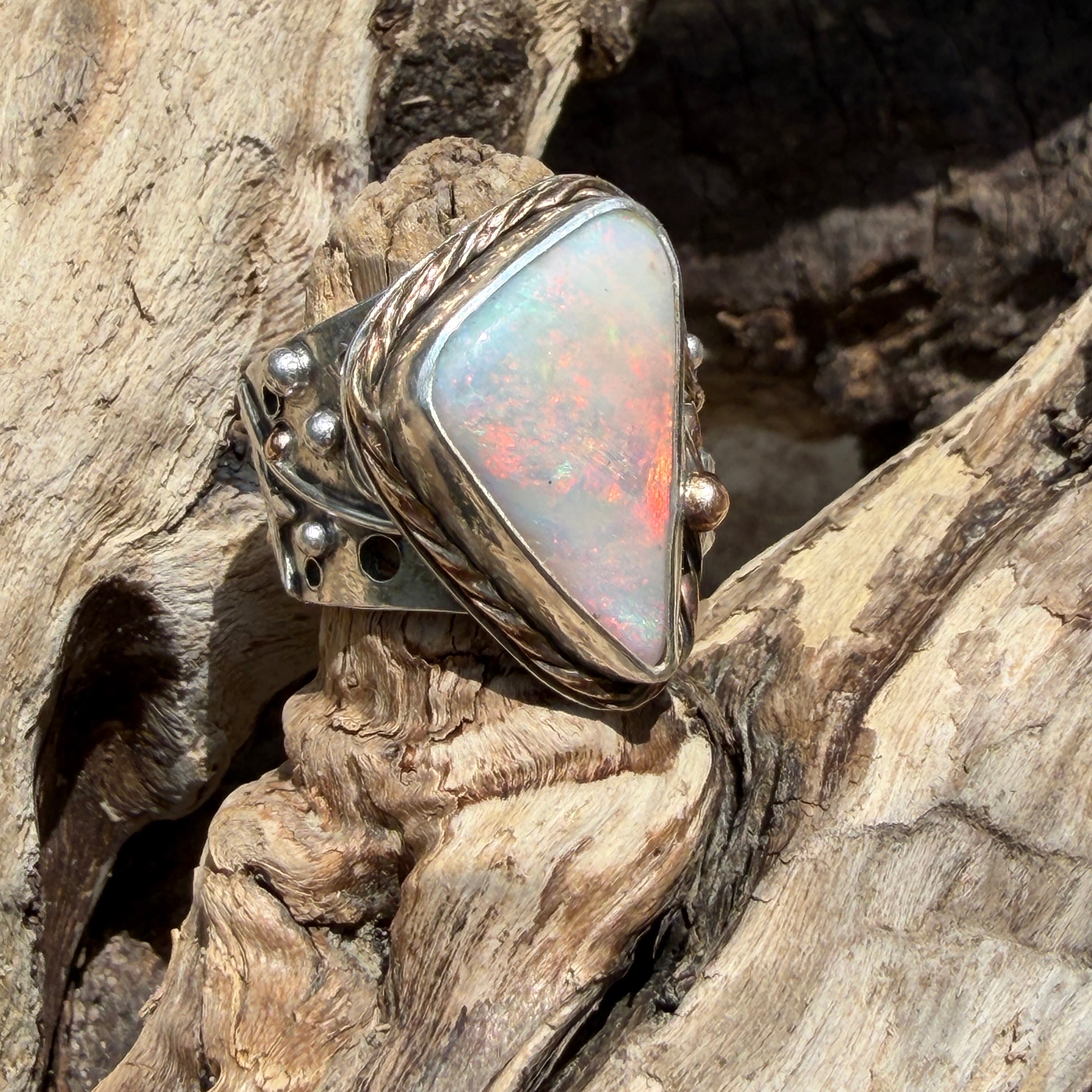 Celestial Tide handcrafted Australian crystal opal ring in .925 sterling silver with a 14K gold rope bezel, gold accents, and sculpted starfish.