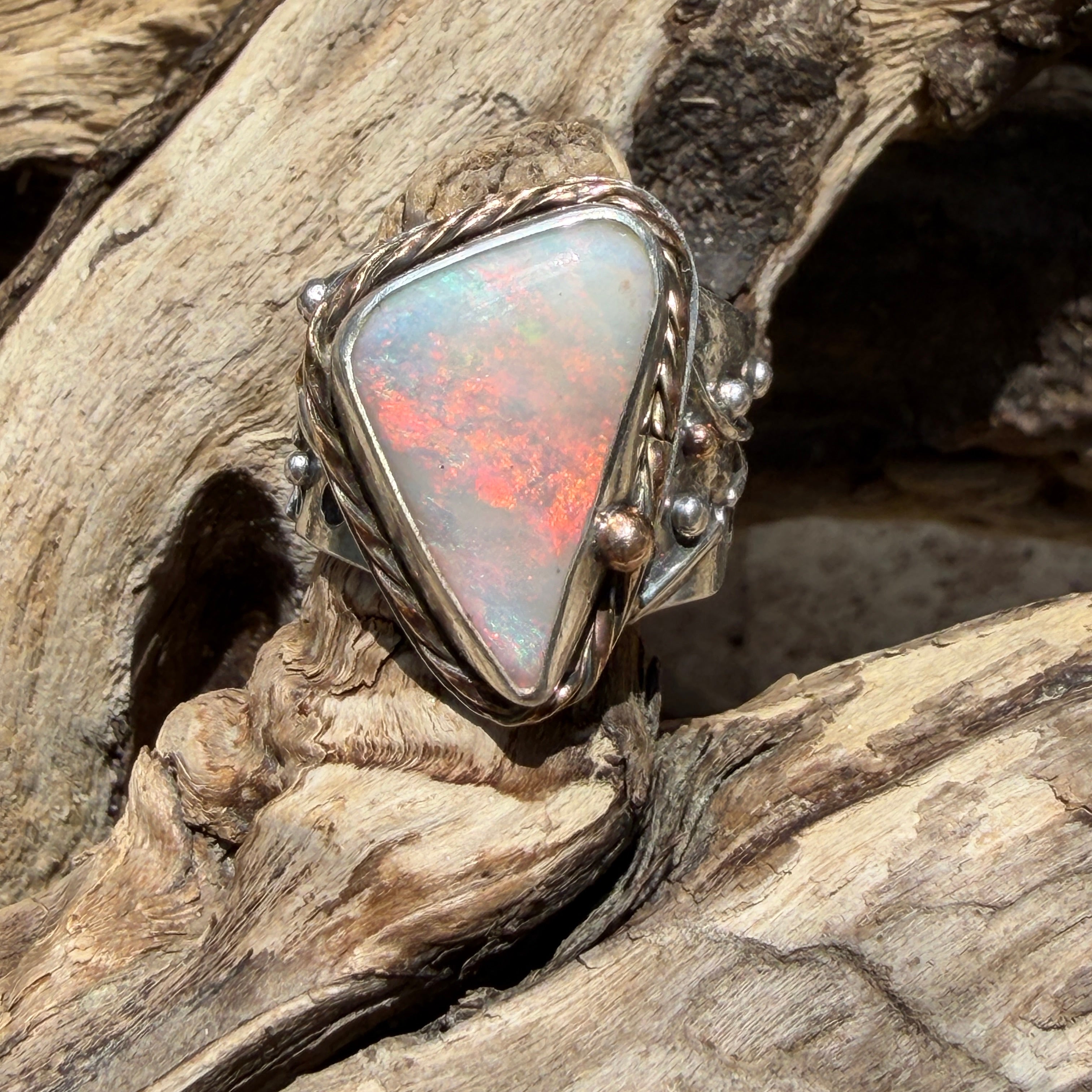 Celestial Tide handcrafted Australian crystal opal ring in .925 sterling silver with a 14K gold rope bezel, gold accents, and sculpted starfish.