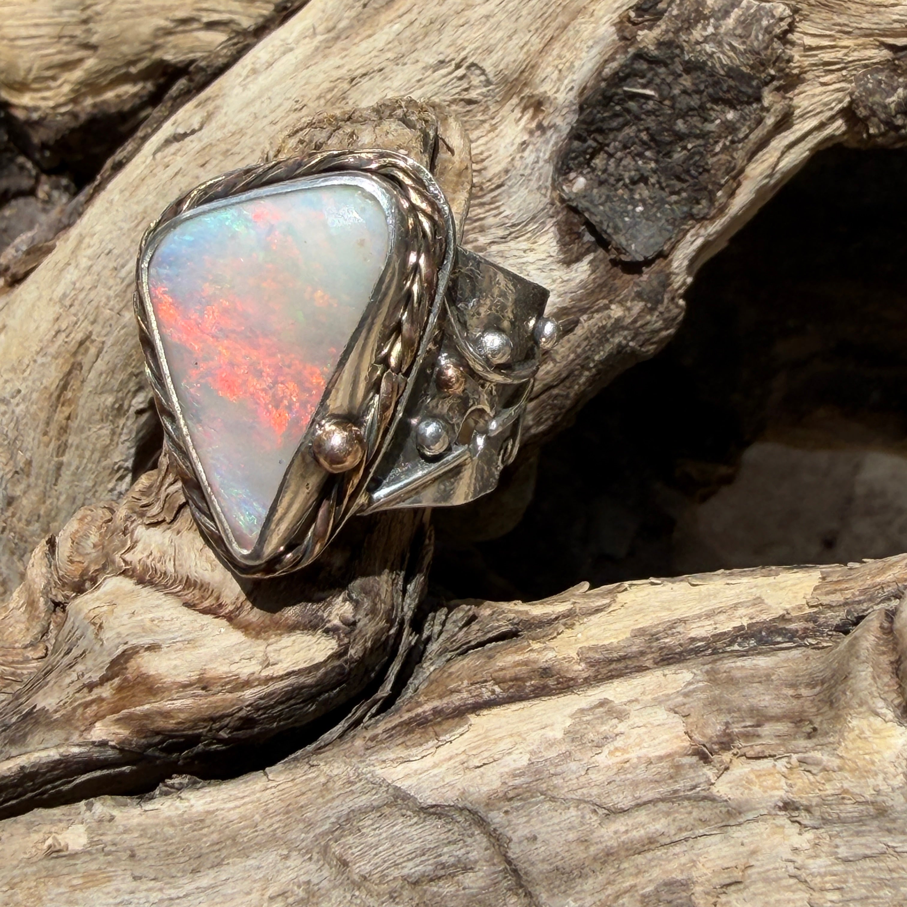 Celestial Tide handcrafted Australian crystal opal ring in .925 sterling silver with a 14K gold rope bezel, gold accents, and sculpted starfish.
