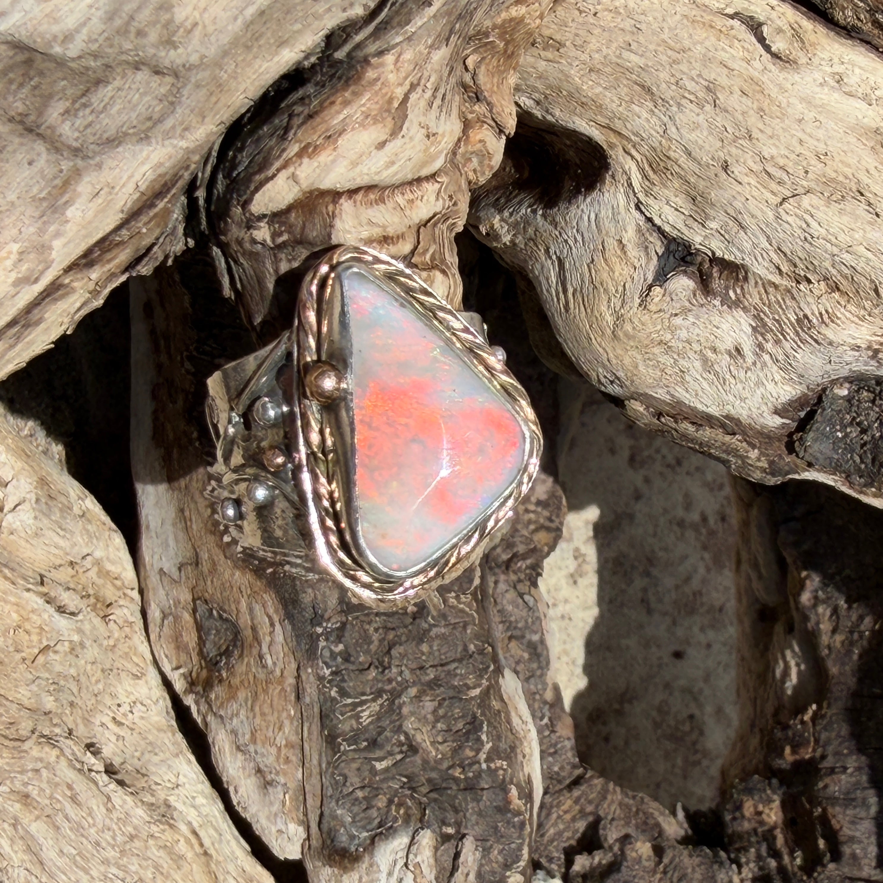 Celestial Tide handcrafted Australian crystal opal ring in .925 sterling silver with a 14K gold rope bezel, gold accents, and sculpted starfish.