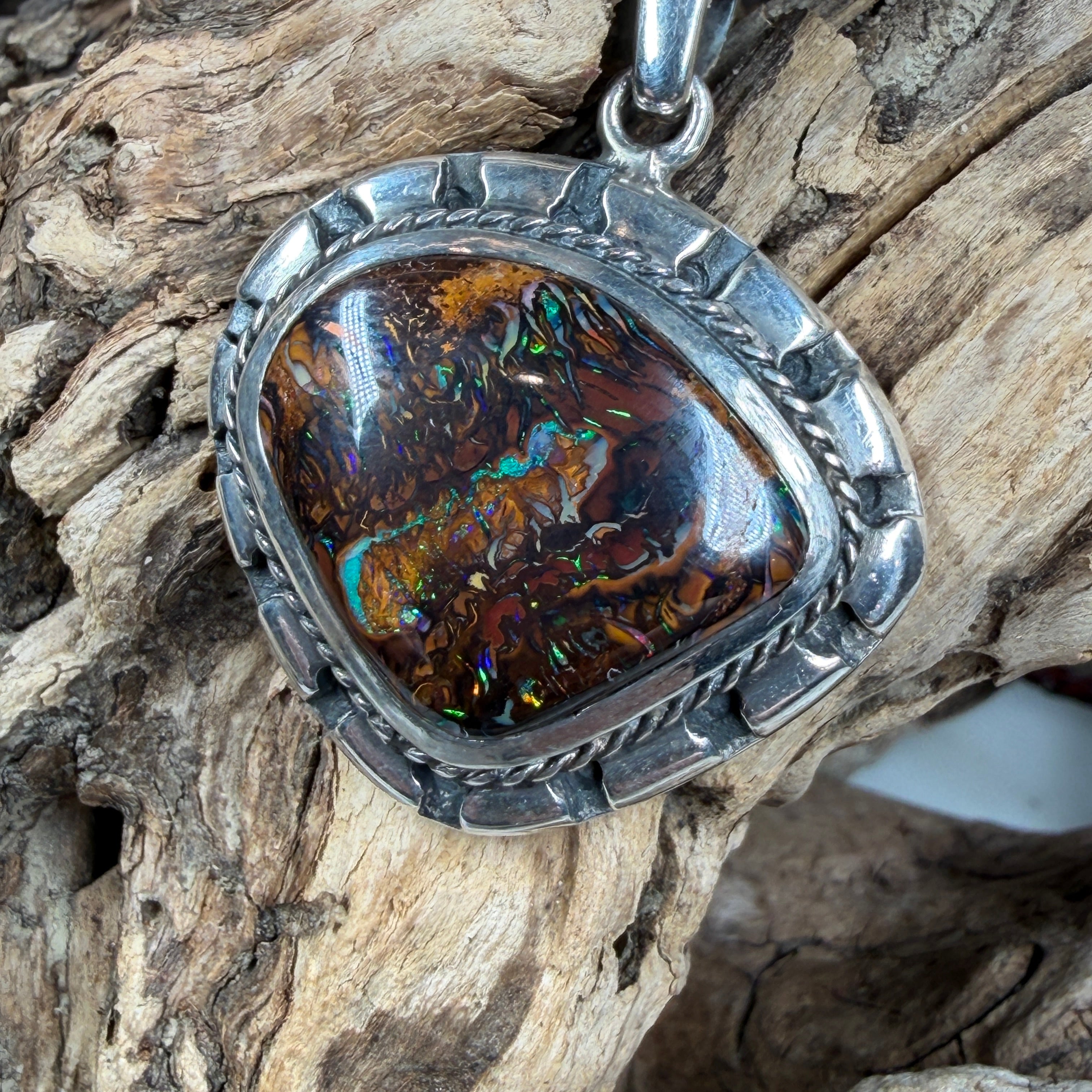Sea Forge Australian Boulder Opal Pendant handcrafted in sterling silver featuring a genuine 20 × 24 mm Boulder Opal with brilliant blue, green, turquoise, and copper flashes.