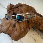 Capture the beauty of shifting light with the Aurora Ridge Boulder Opal Cuff Bracelet, a one-of-a-kind handcrafted piece inspired by the colors of the northern sky. 