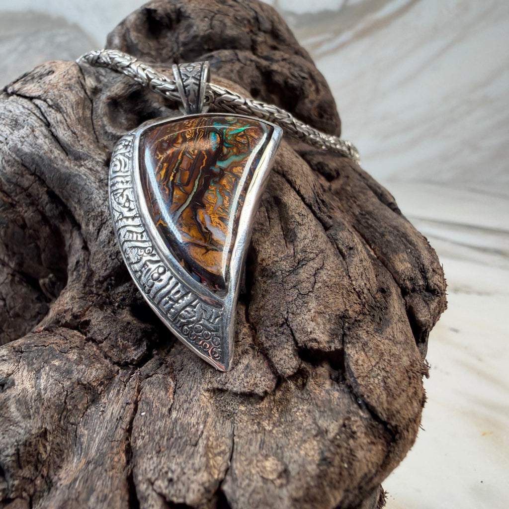 Silver pendant with a colorful stone 

