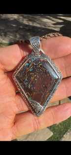 Luxury handcrafted Boulder Opal pendant set in solid .925 sterling silver.
