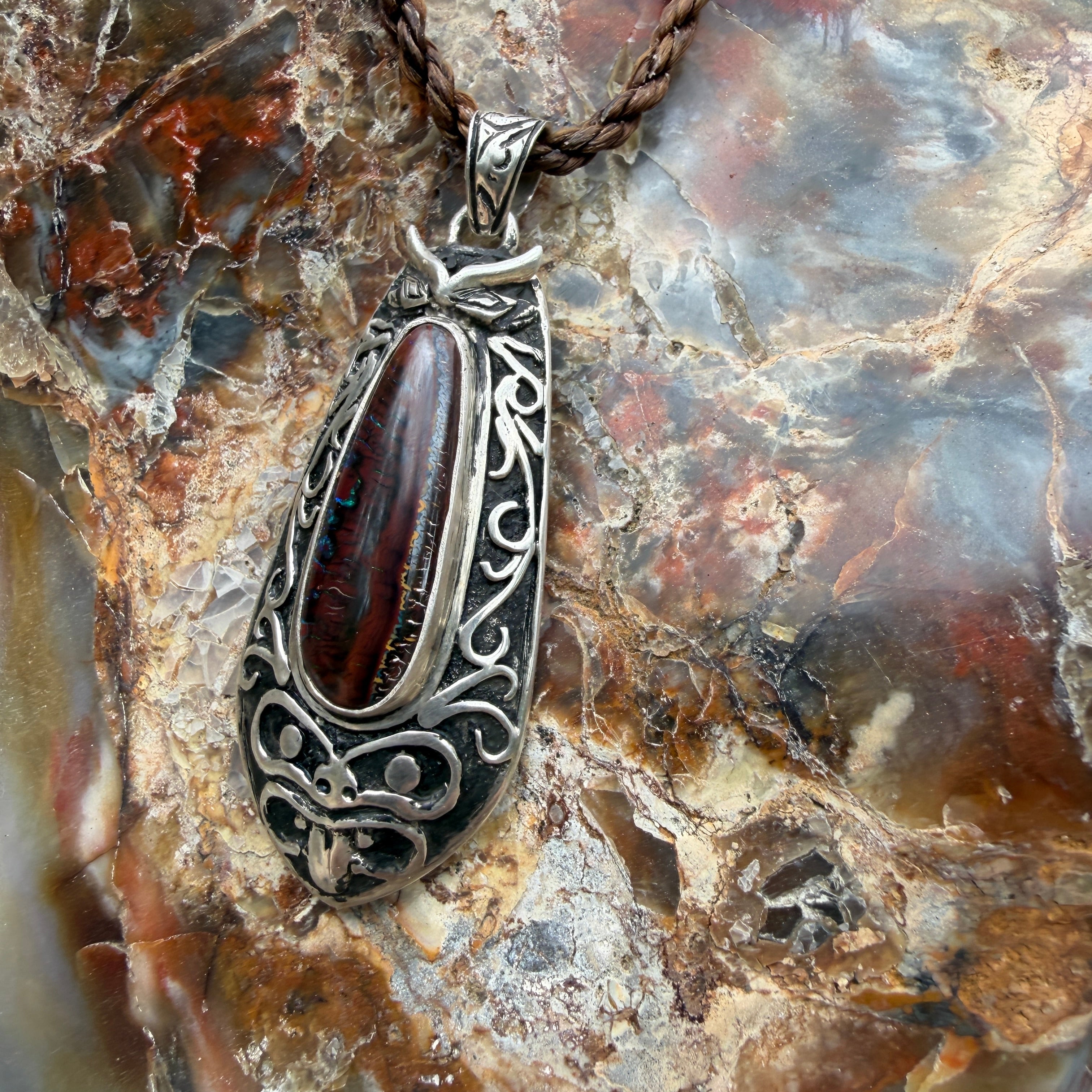 One-of-a-kind Ironwood Ember pendant with genuine Australian Boulder Opal, oxidized sterling silver, and Māori-inspired craftsmanship.