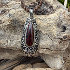 One-of-a-kind Ironwood Ember pendant with genuine Australian Boulder Opal, oxidized sterling silver, and Māori-inspired craftsmanship.