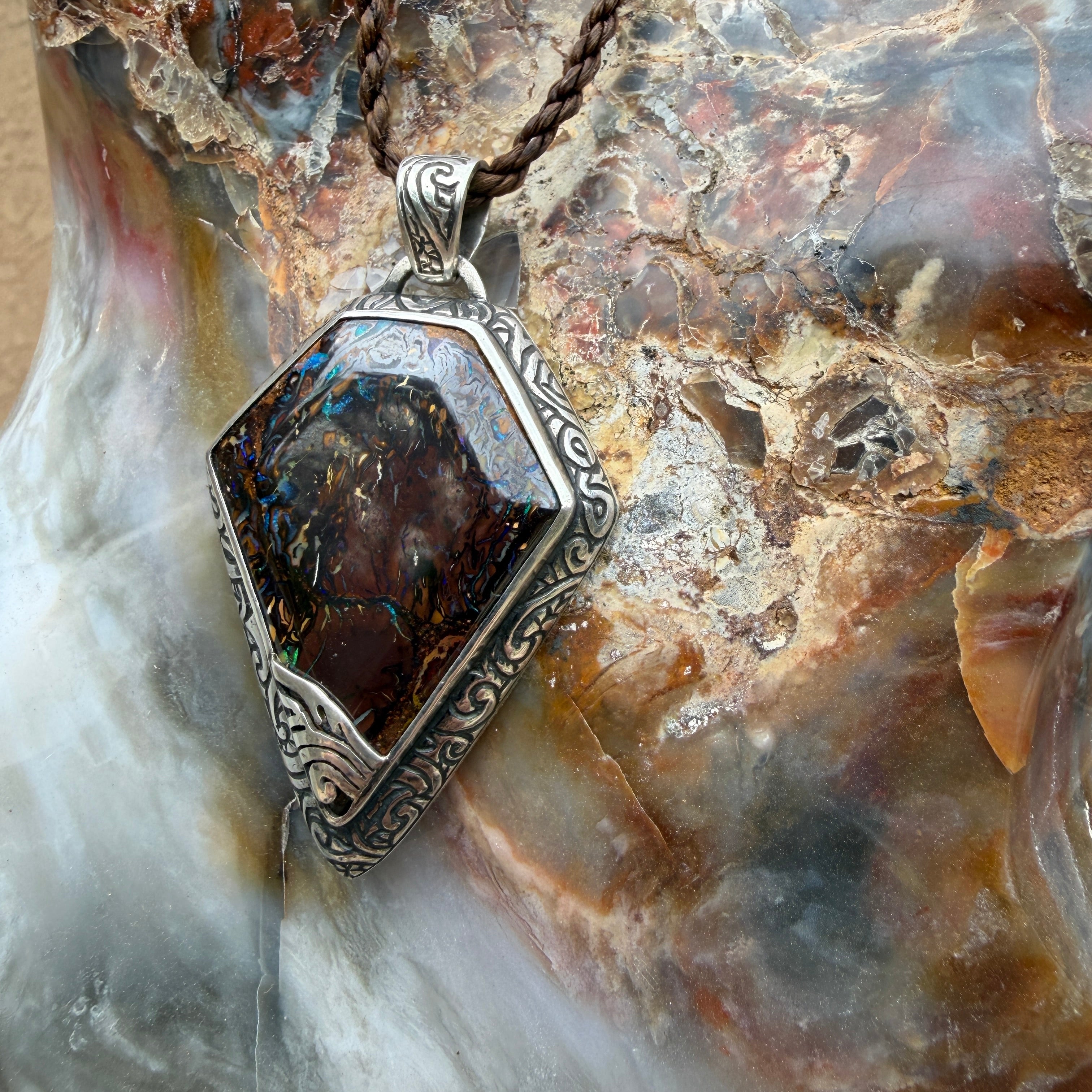 Artisan sterling silver pendant featuring a unique Australian Boulder Opal centerpiece.