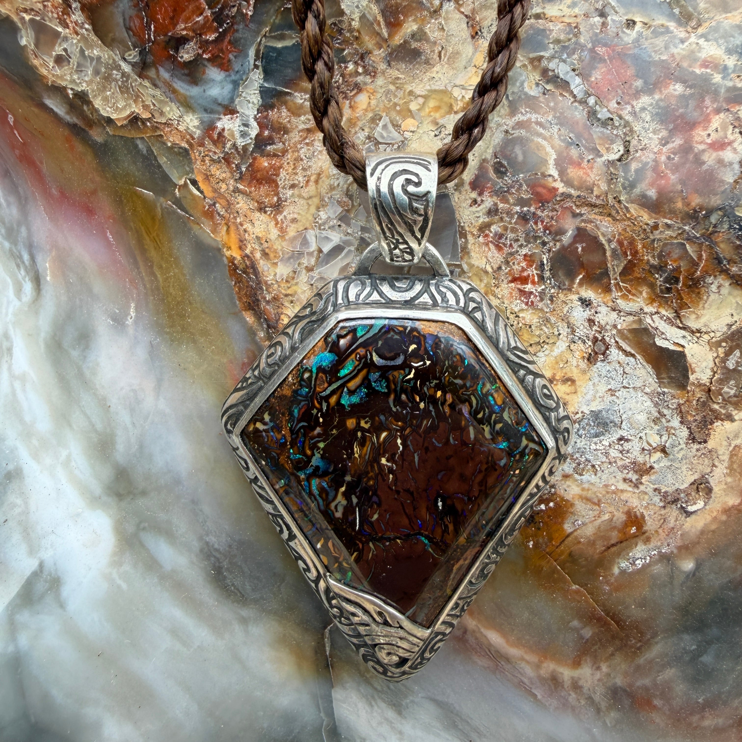 Statement Australian Boulder Opal pendant with handcrafted silver setting and braided wax cord.