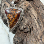 Close-up of Driftwood pendant showcasing intricate natural ironstone veining in Australian Boulder Opal.