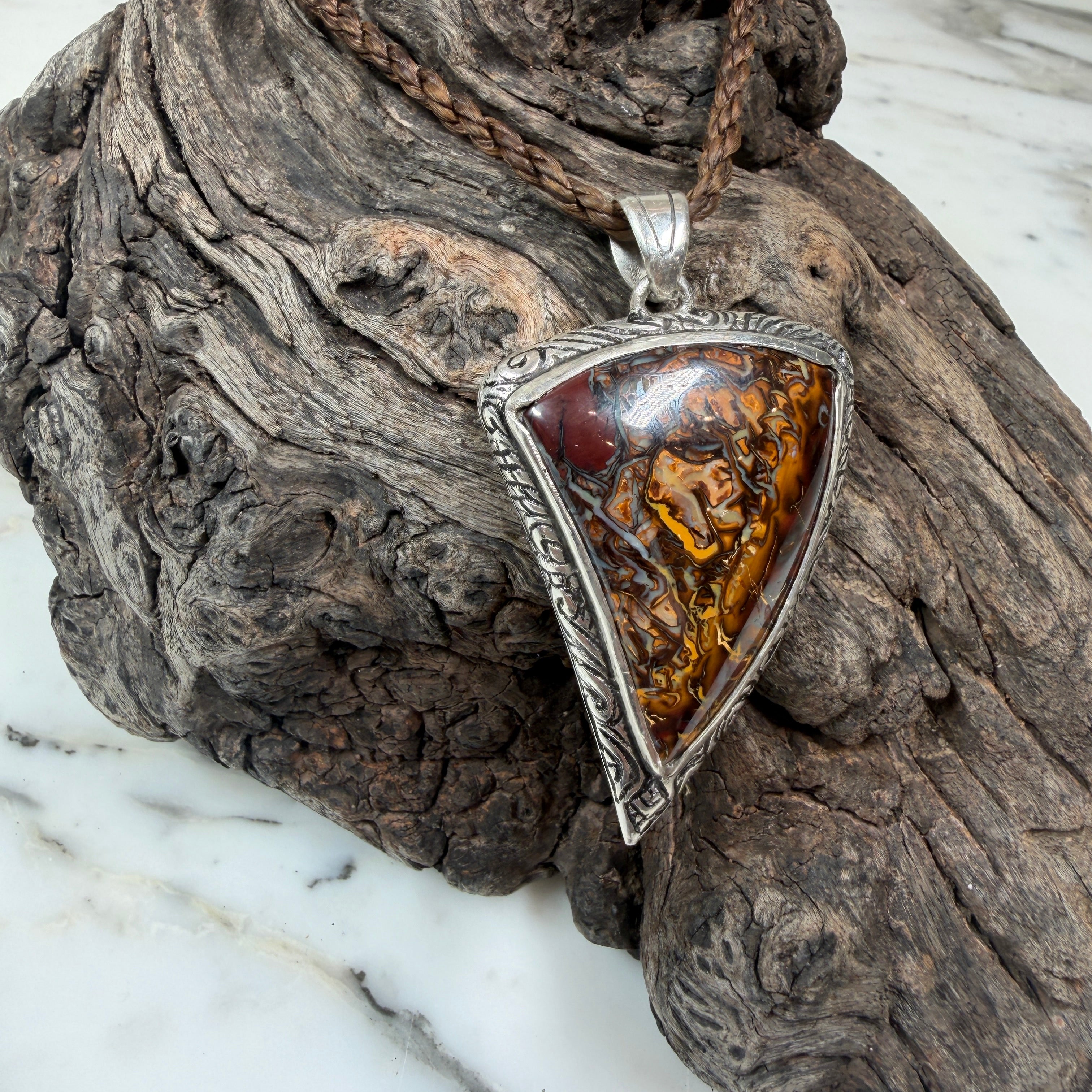 Handcrafted sterling silver pendant with a genuine Australian Boulder Opal inspired by weathered driftwood.