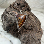 Australian Boulder Opal pendant with Māori-inspired engraved sterling silver and oxidized finish.