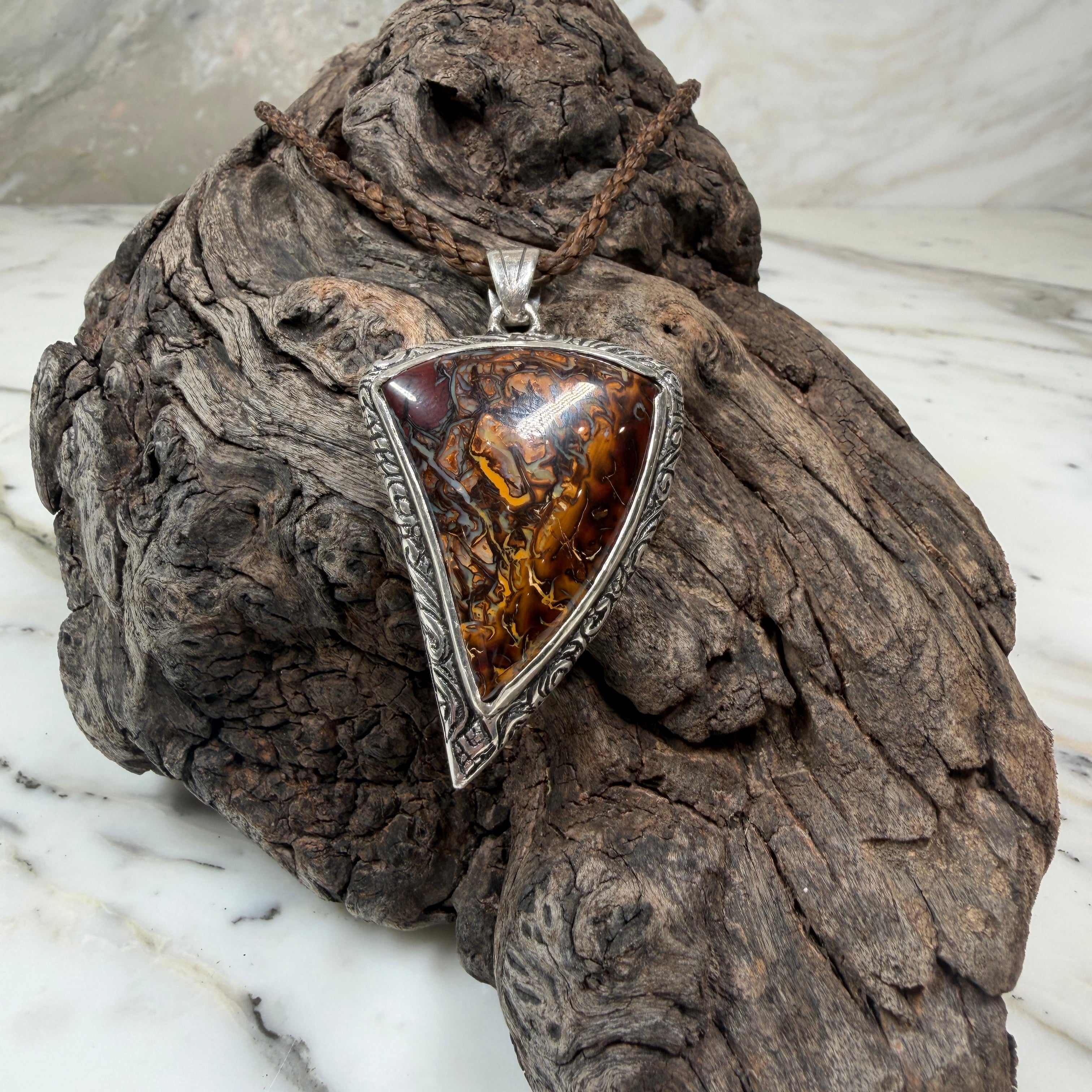Australian Boulder Opal pendant with Māori-inspired engraved sterling silver and oxidized finish.