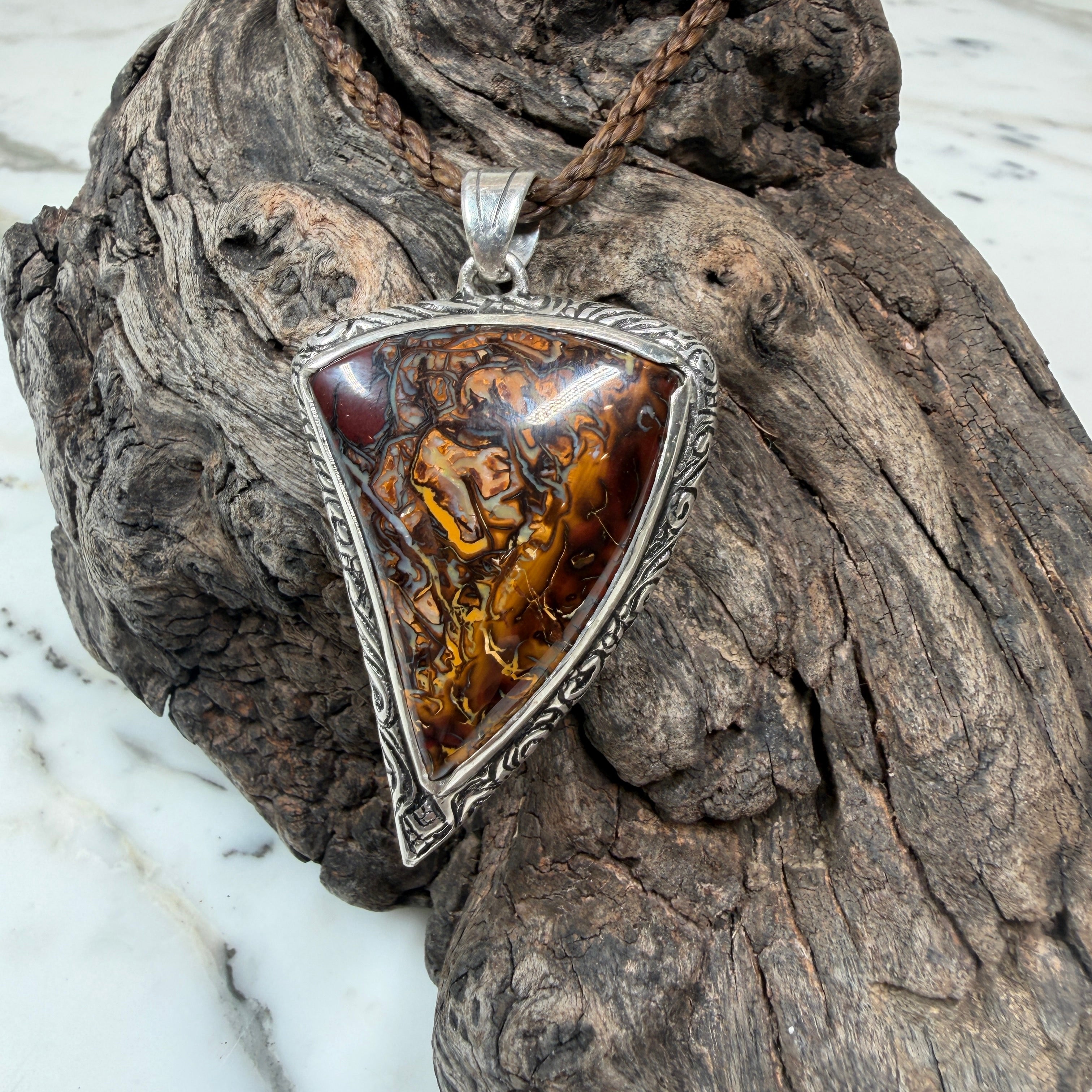 Artisan sterling silver pendant featuring a unique Australian Boulder Opal with rich chocolate brown and bronze tones.
