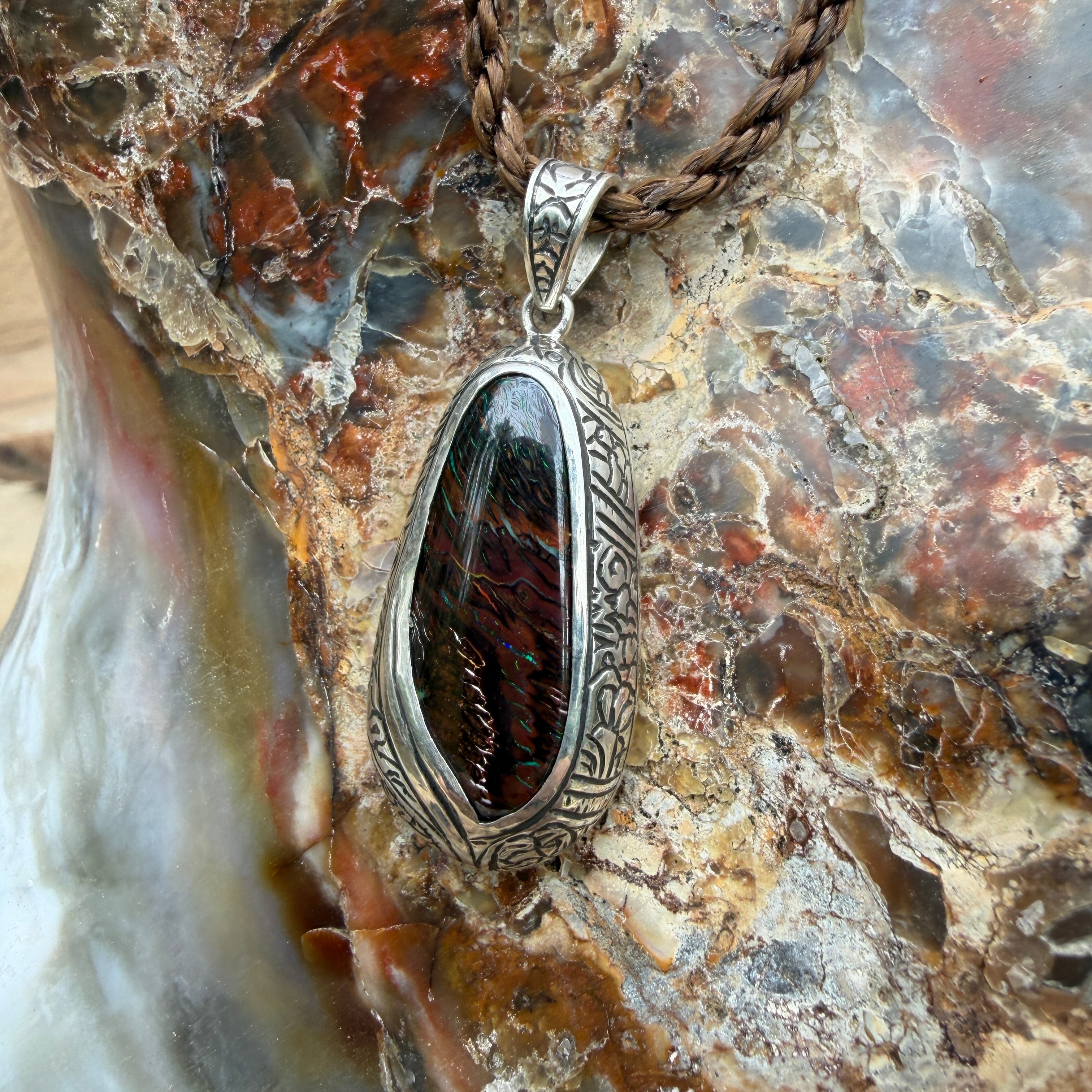 Handcrafted sterling silver pendant featuring a natural Boulder Opal inspired by Polynesian wayfinding.