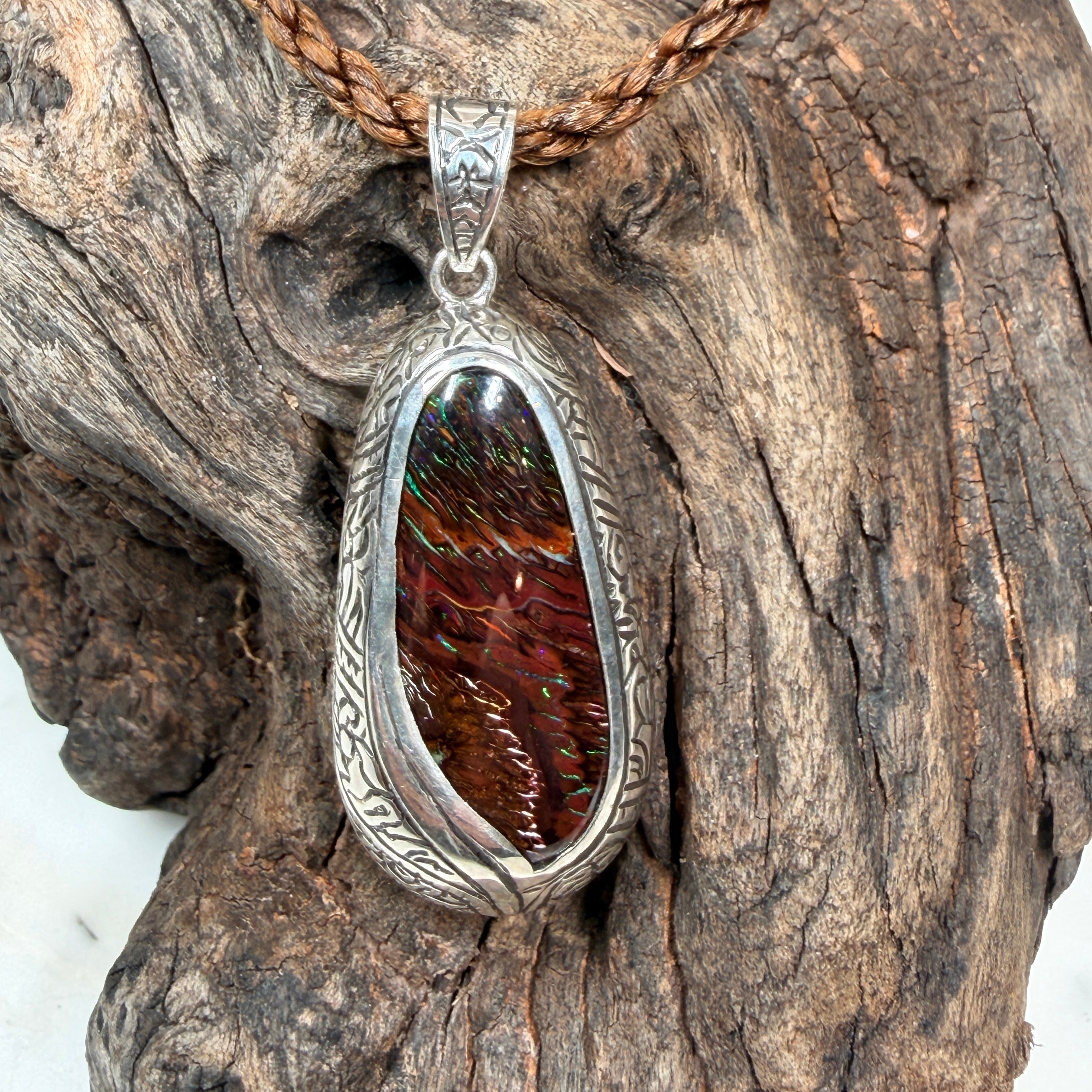 Natural Australian Boulder Opal jewelry featuring earthy ironstone tones and brilliant blue-green colors.