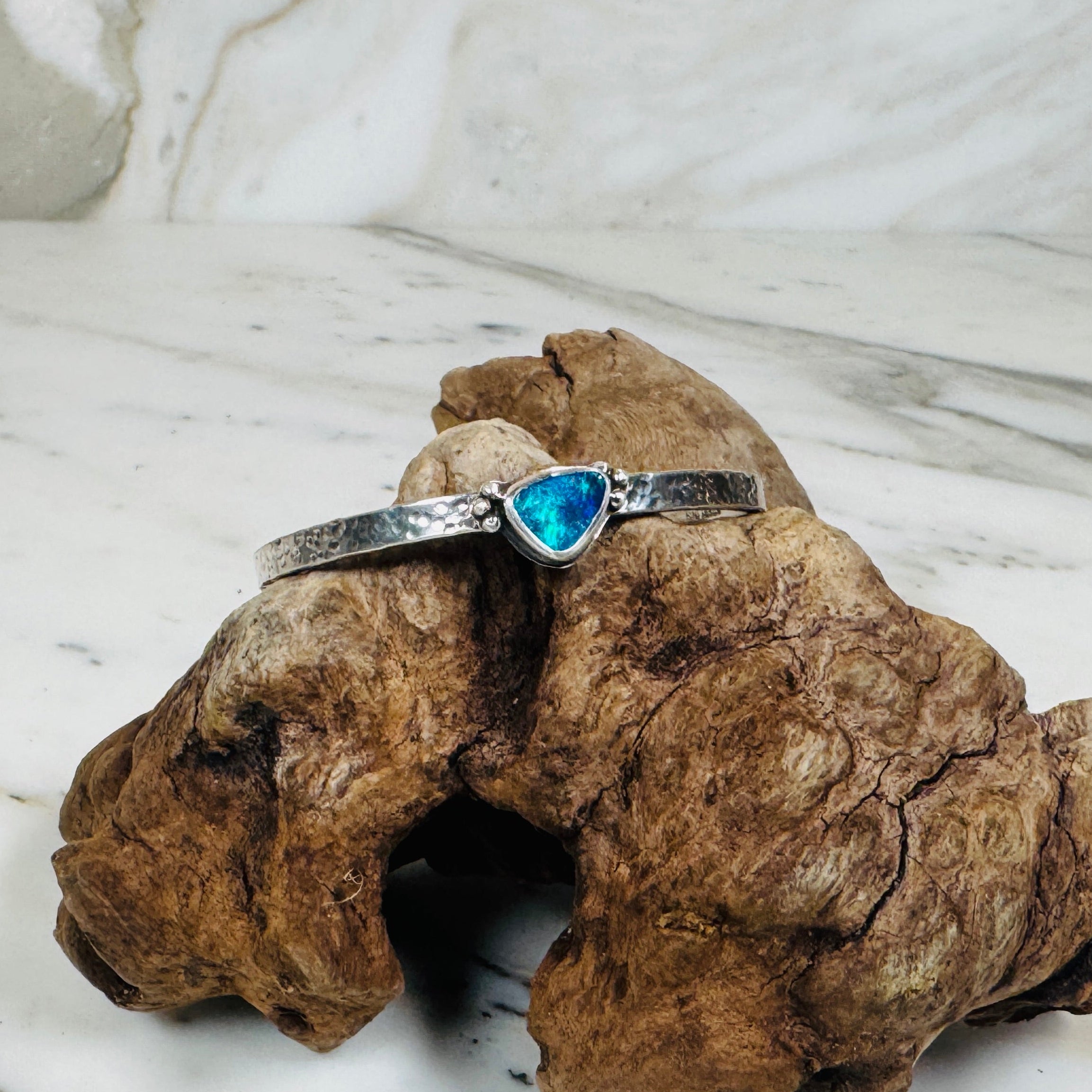 .925 Sterling Silver cuff with blue and green Australian Boulder Opal stone on driftwood.