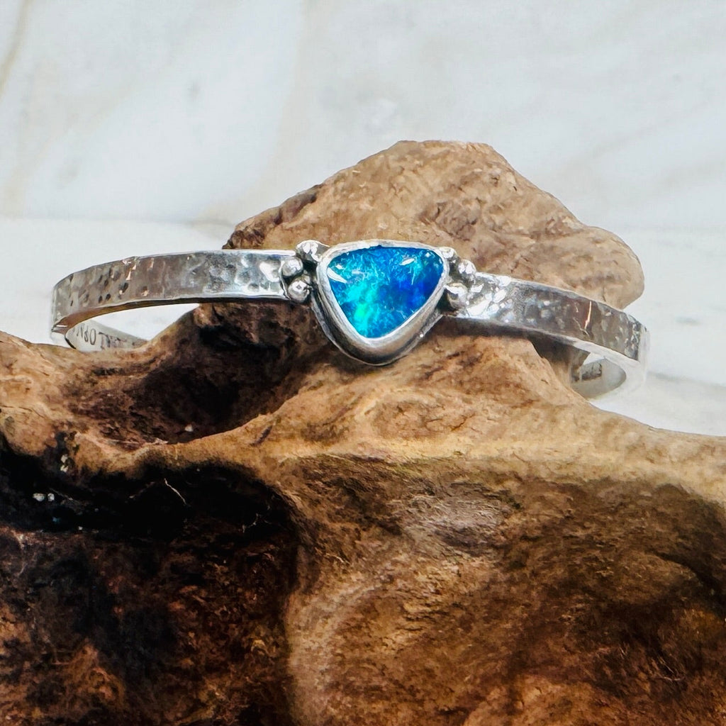 .925 Sterling Silver cuff with blue and green Australian Boulder Opal stone on driftwood.