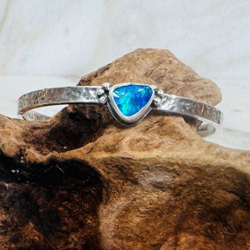 .925 Sterling Silver cuff with blue and green Australian Boulder Opal stone on driftwood.
