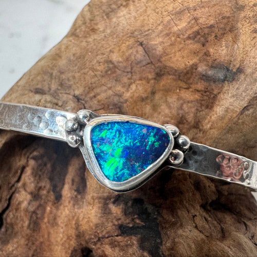 .925 Sterling Silver bracelet with an Australian Boulder Opal green and blue stone in a hammered cuff setting
