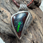 Ancient-inspired Australian Boulder Opal pendant with handcrafted sterling silver frame and oxidized engraving.
