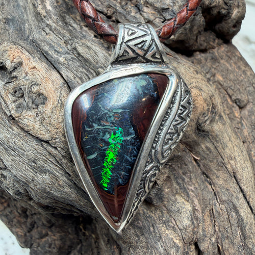 Ancient-inspired Australian Boulder Opal pendant with handcrafted sterling silver frame and oxidized engraving.