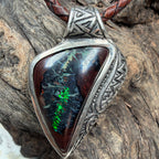 Unique handmade sterling silver pendant with natural Boulder Opal displaying emerald green, turquoise, and orange flashes.