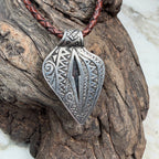 Statement pendant crafted from sterling silver featuring a natural Australian Boulder Opal and detailed engraved backplate.